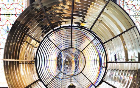 Former Lighthouse Keeper Gerald Butler at the National Maritime Museum of Ireland, Dun Laoghaire, in front of the light from Baily lighthouse in Howth from 1902