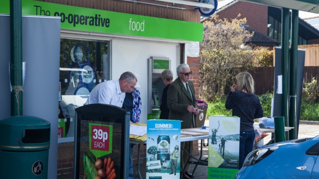 A woman and a man having a conversation during an audience consultation outside a supermarket in Bedfordshire